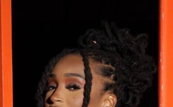 A close up of a person with dreadlocks