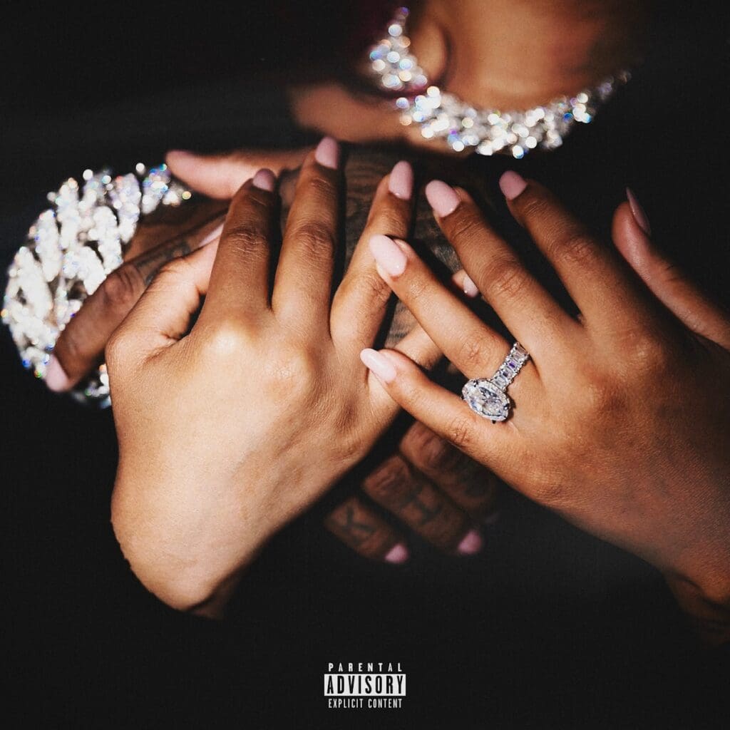 Couple's hands with diamond rings.