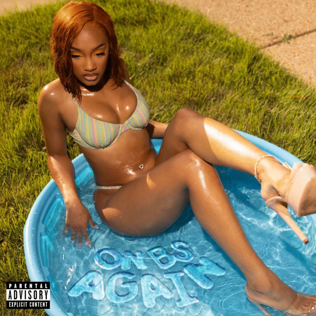 Woman relaxing in small plastic pool.