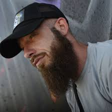 Man with a beard wearing a cap.
