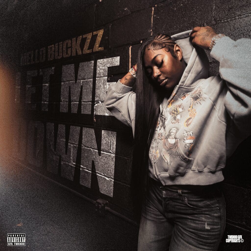 Person in hoodie against dark urban background.