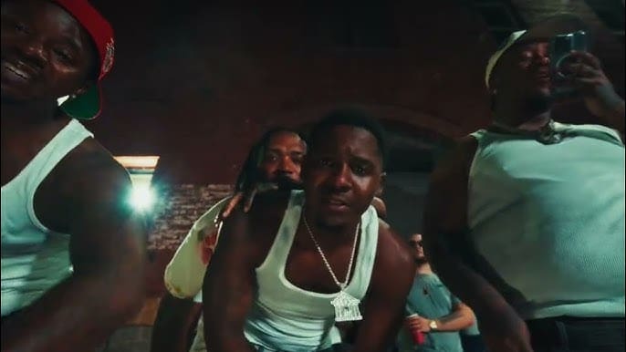 Group of men posing in dim lighting.